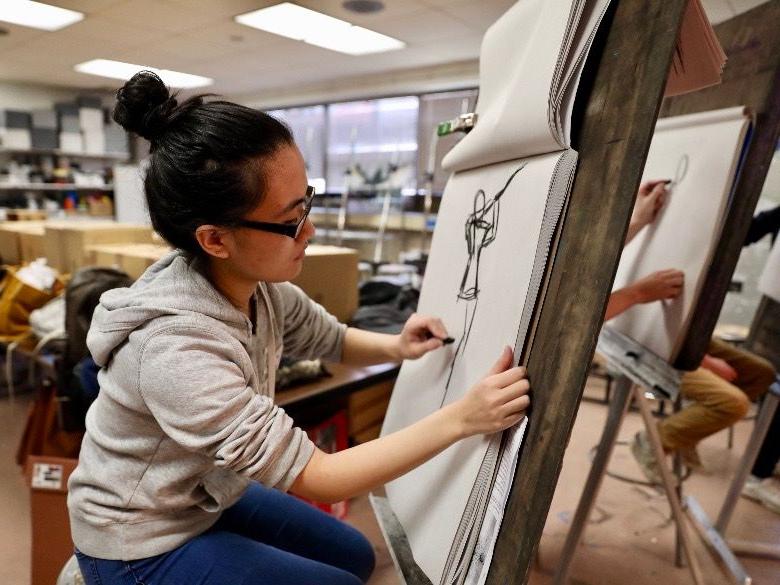 Student sketching in art class